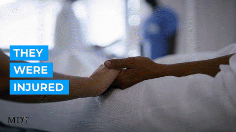 Two people holding hands in a hospital bed. Two people holding hands in a hospital bed.
